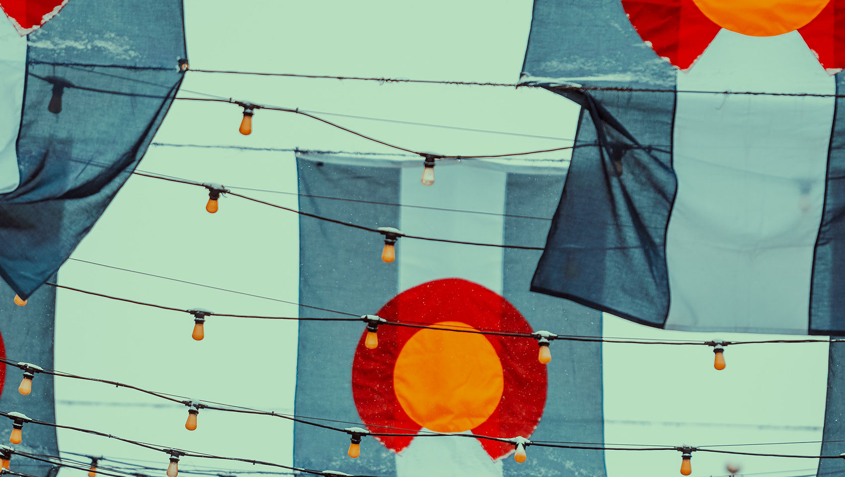 multiple colorado flags hanging from string lights