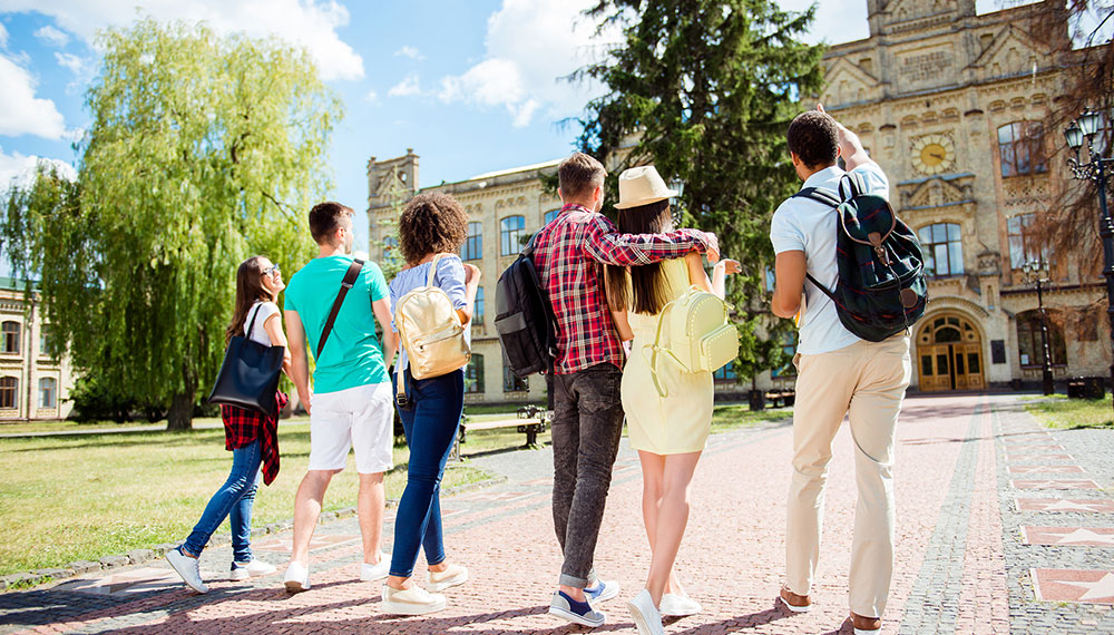 college students walking towards college building