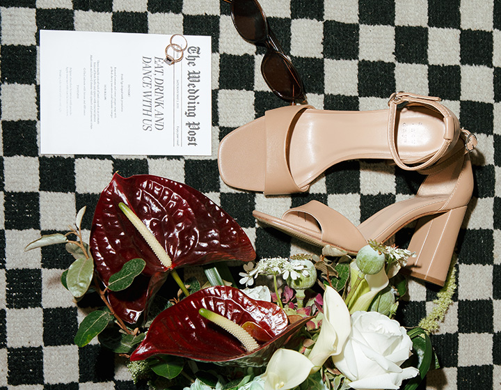 bridal details including wedding shoes, flowers and wedding invitation