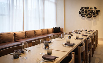 Claret private dining room with long table, seating and a long window seat bench